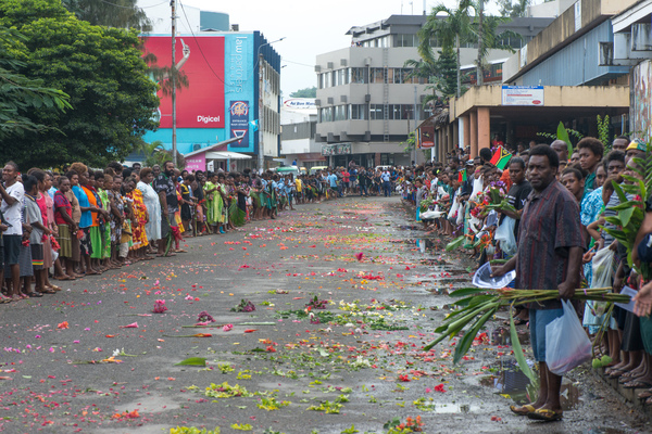 School children and members of the public throng the roadway in downtown Port Vila as they await a kilometre-long funeral procession carrying President Baldwin Lonsdale to be flown to his home island of Mota Lava.
